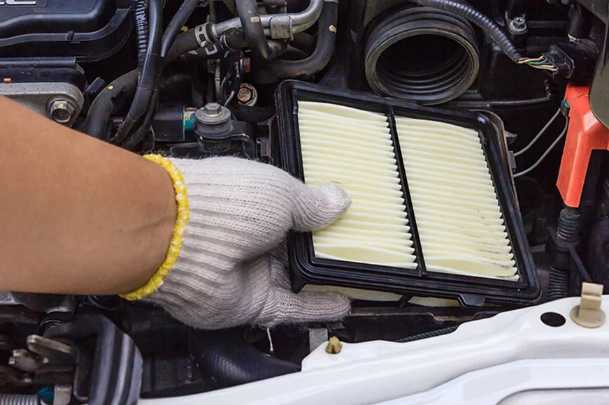 GM technician replacing an air filter.
