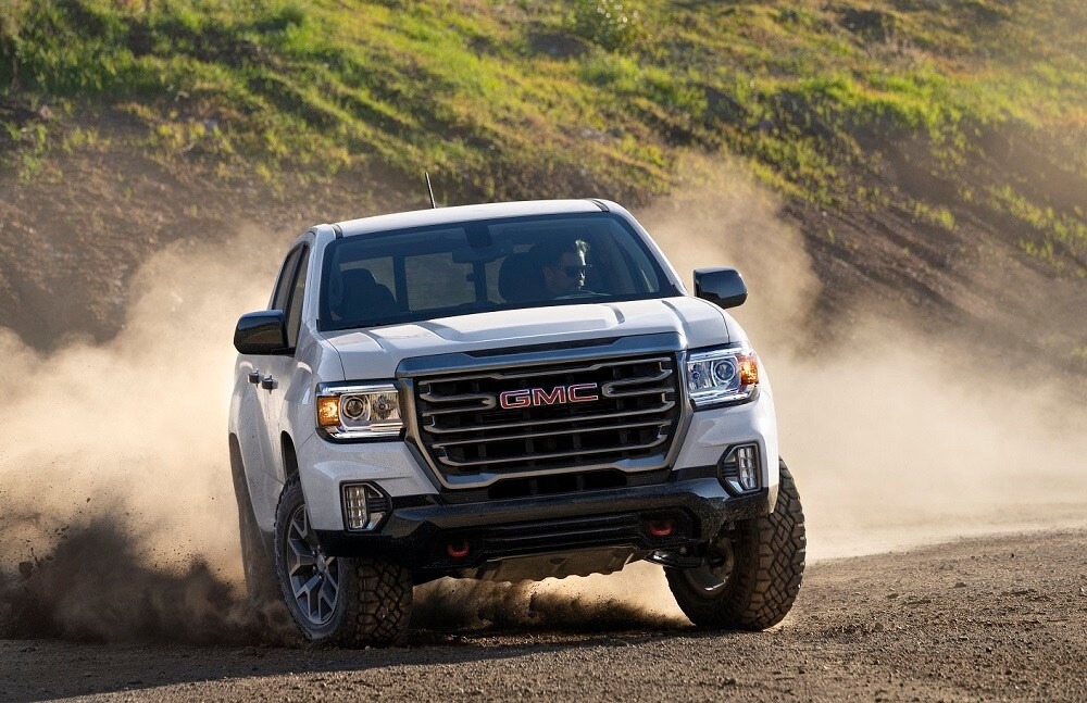 GMC truck driving in the dirt.