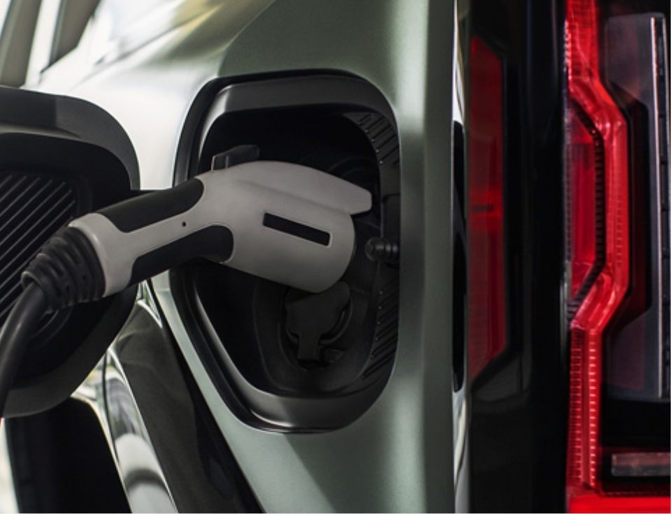 Close up of charging port with charger plugged in on a GMC Hummer EV SUV - C. Wimberley GMC in DOWAGIAC MI