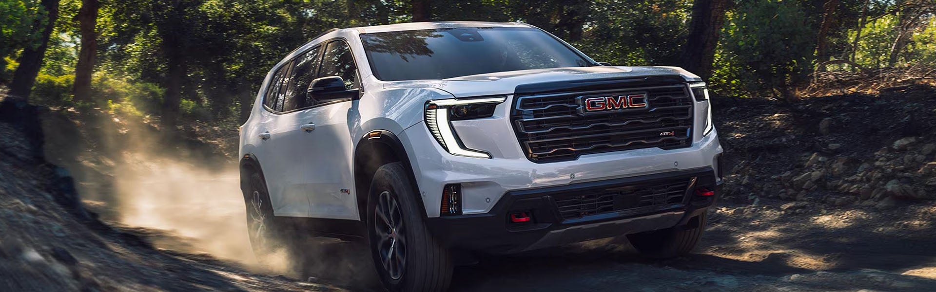 2026 GMC Acadia Hero image showing a modern mid-size SUV parked outdoors highlighting bold styling