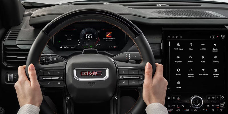 2026 GMCAcadia driving on road showcasing strong turbo engine performance and smooth everyday capability.