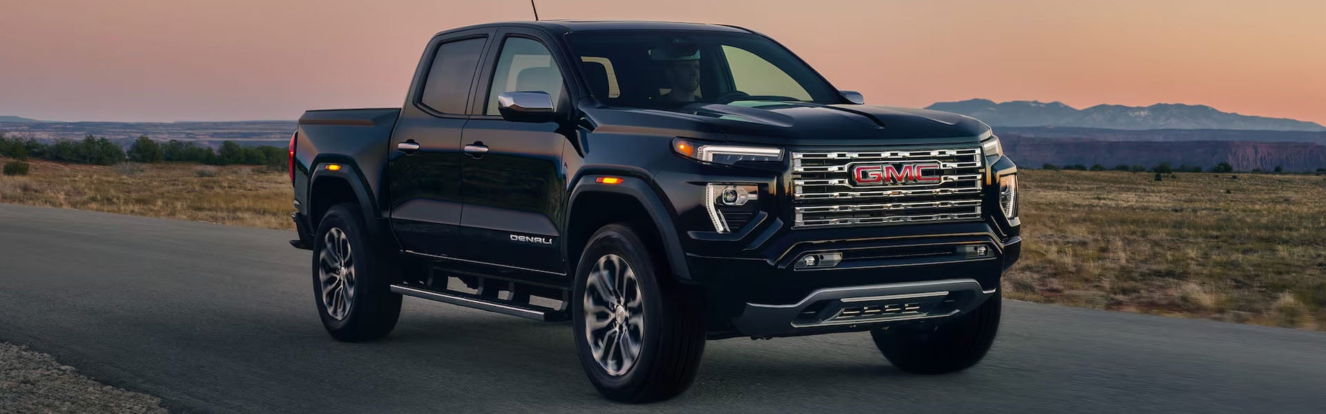 2026 GMC Canyon AT4X off-road pickup truck navigating rocky terrain