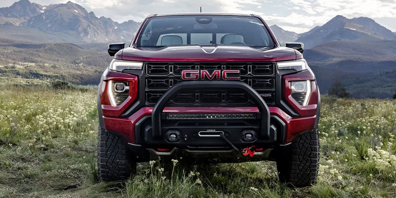 2026 GMC Canyon AT4X parked in a mountain landscape showcasing off-road performance and rugged design