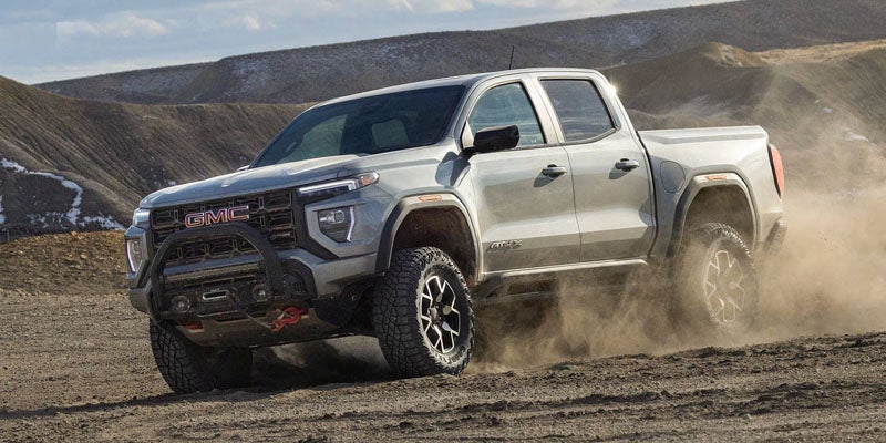 2026 GMC Canyon midsize truck driving off-road.