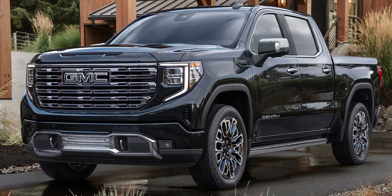 Black 2026 GMC Sierra 1500 parked outdoors highlighting bold design and safety features.