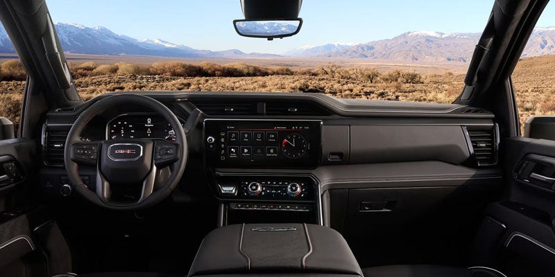 2026 GMC Sierra 2500 HD dashboard with digital displays, infotainment system, and panoramic cabin view.