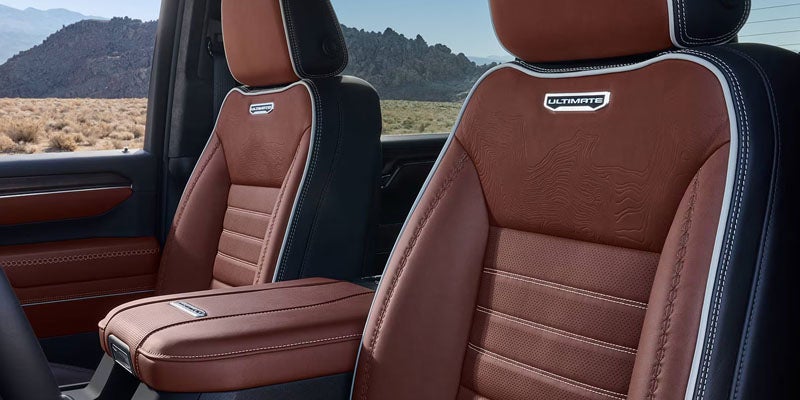 Premium brown leather interior of the 2026 GMC Sierra 2500 HD with spacious front seating.