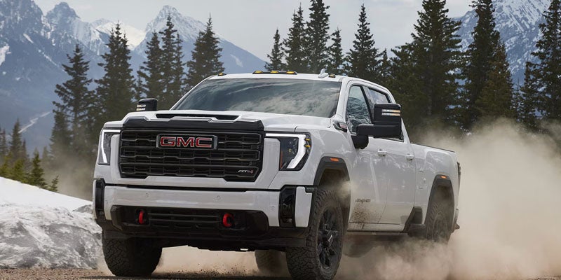 White 2026 GMC Sierra 2500 HD showcasing available trim levels and off-road capability.